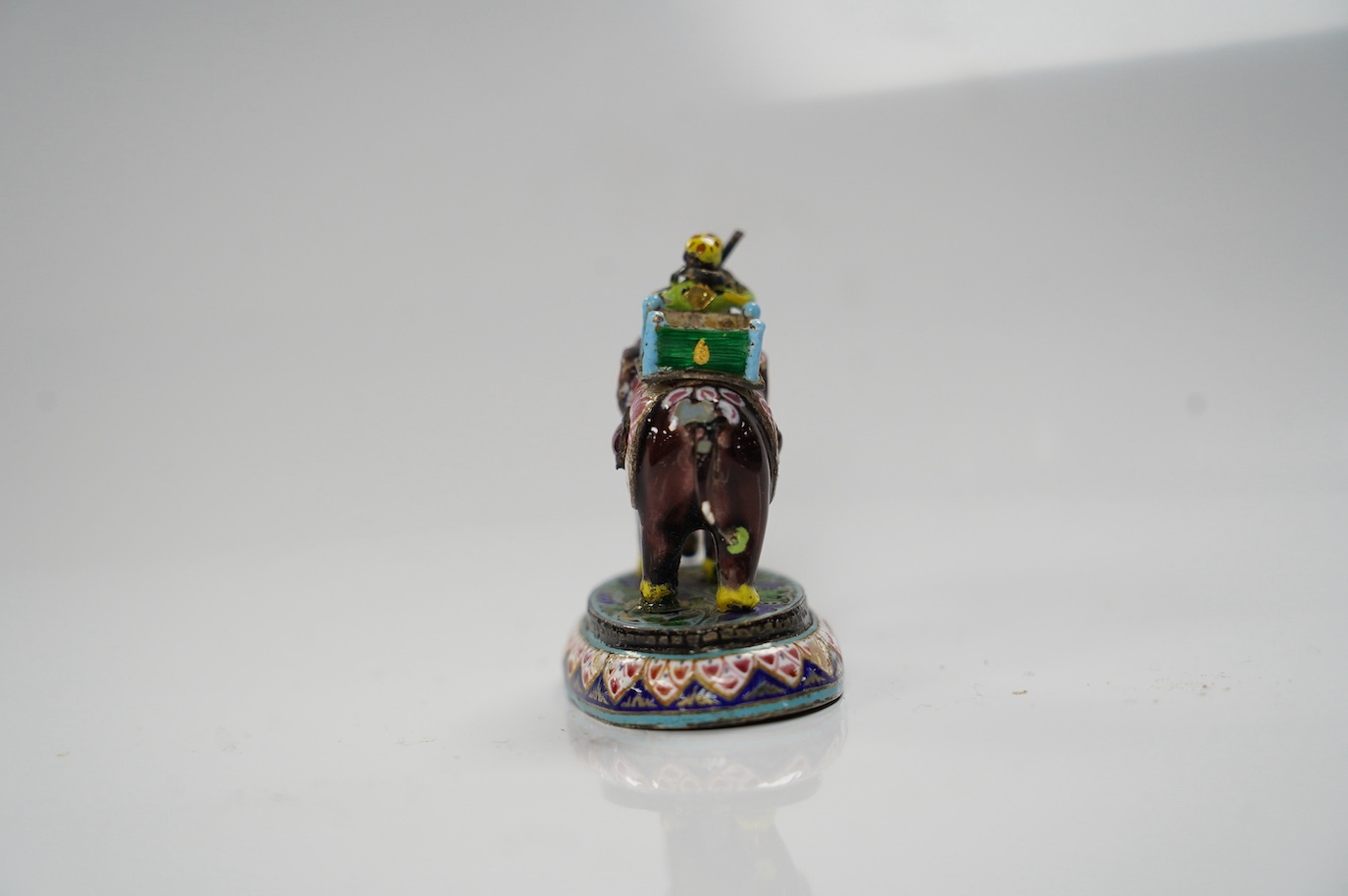 An Indian enamelled white metal elephant and mahout, 5cm. Condition - good